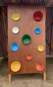 Lots of coloured buckets on a board