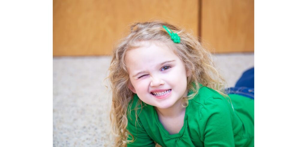 Little girl winking