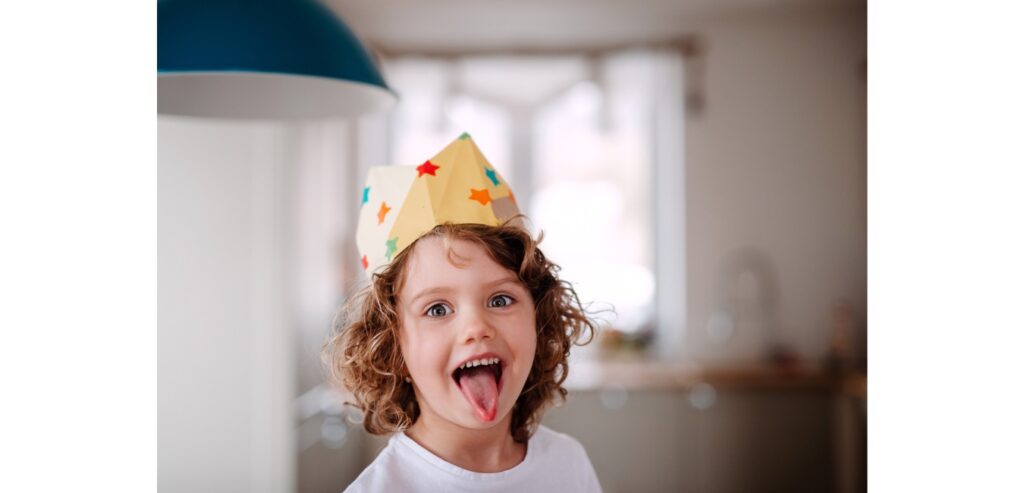 Little boy wearing a decorated crown