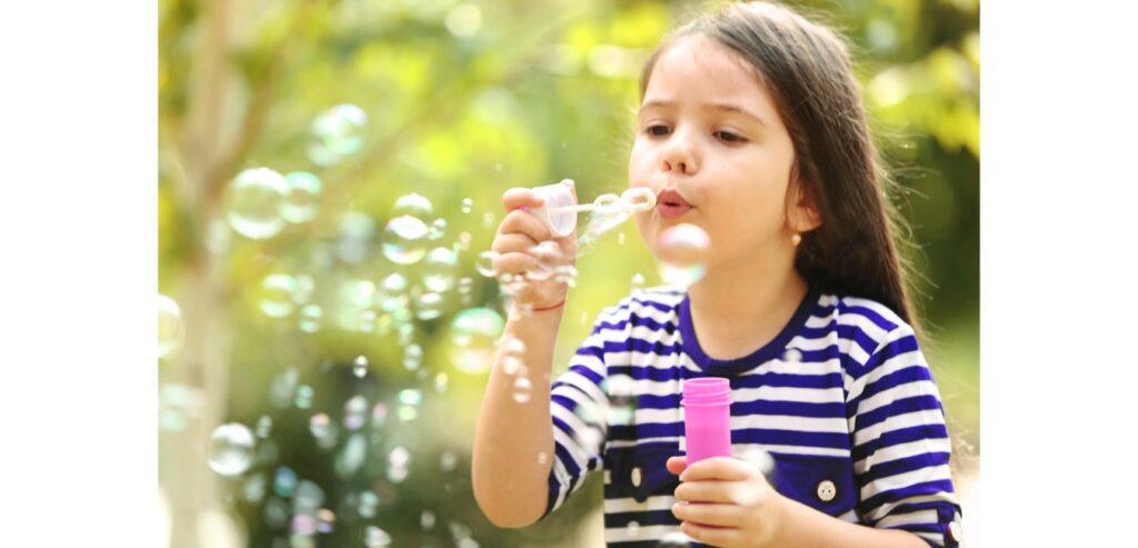 Kid blowing bubbles