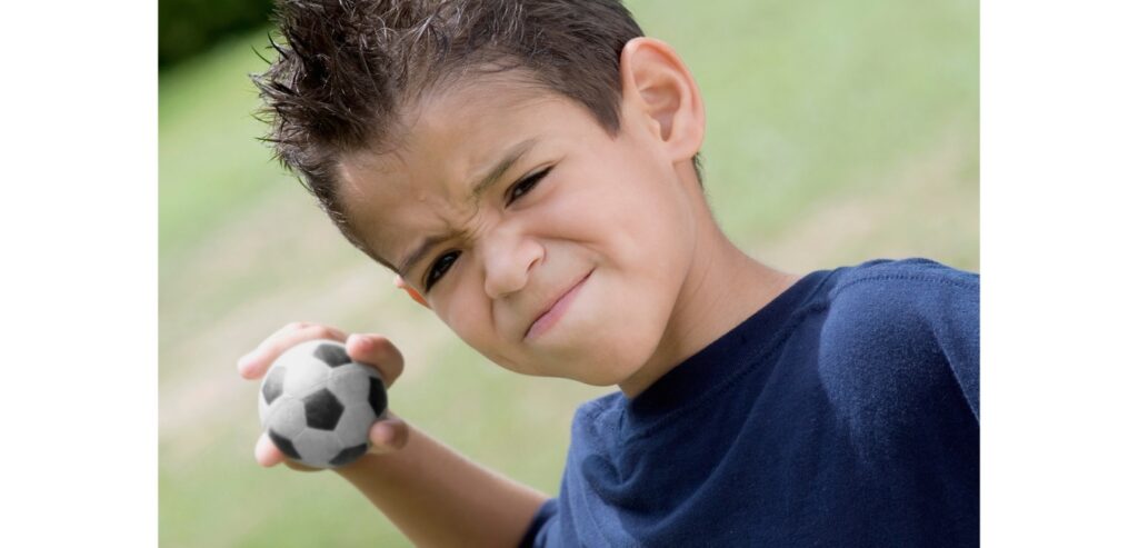 Boy throwing a small bag