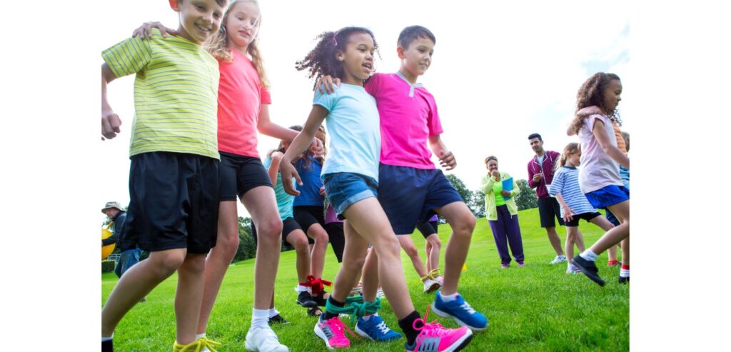 Children running three legged race
