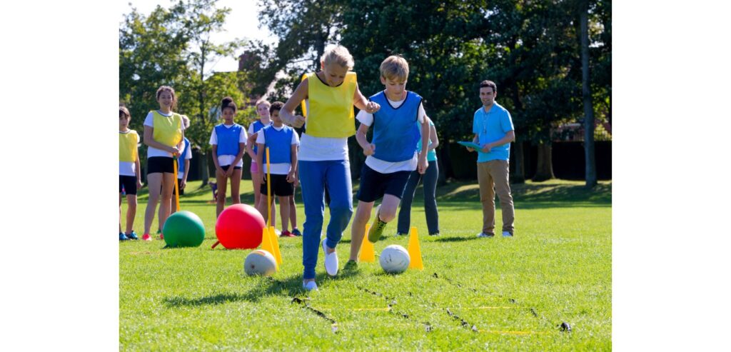 Kids playing on a filed with a ball