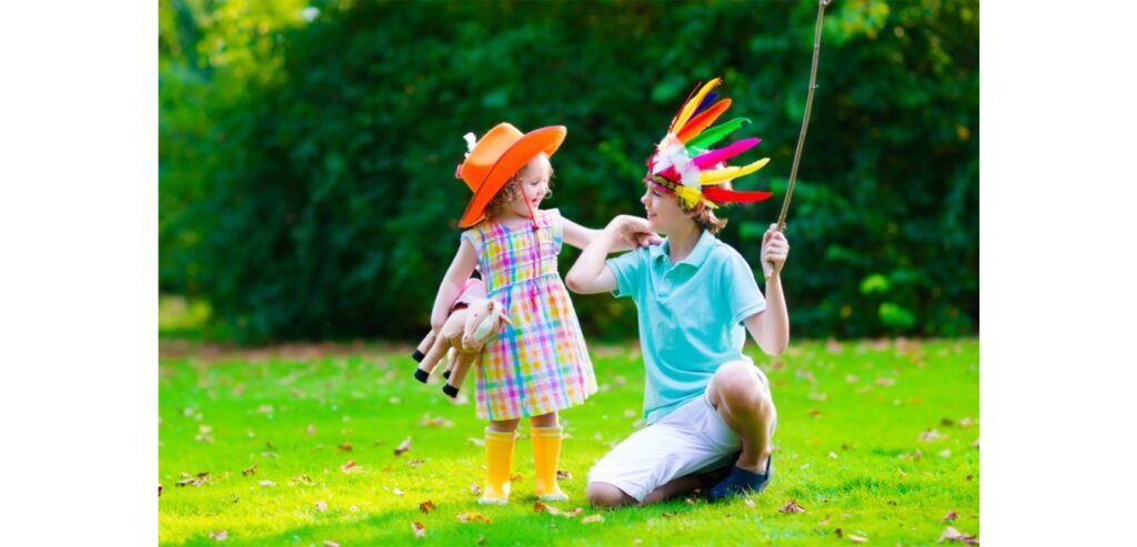 Girl and boy dressed as a cowboy and an indian