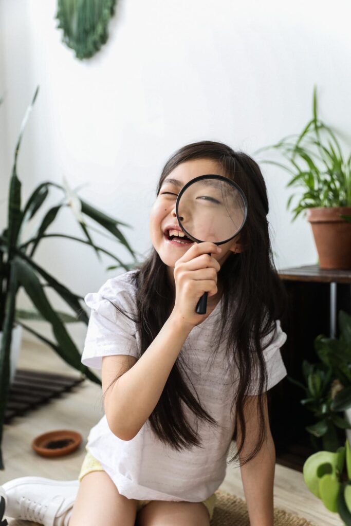 Little girls with magnifying glass