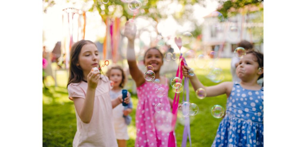 Group of girls blowing bubbles in the park