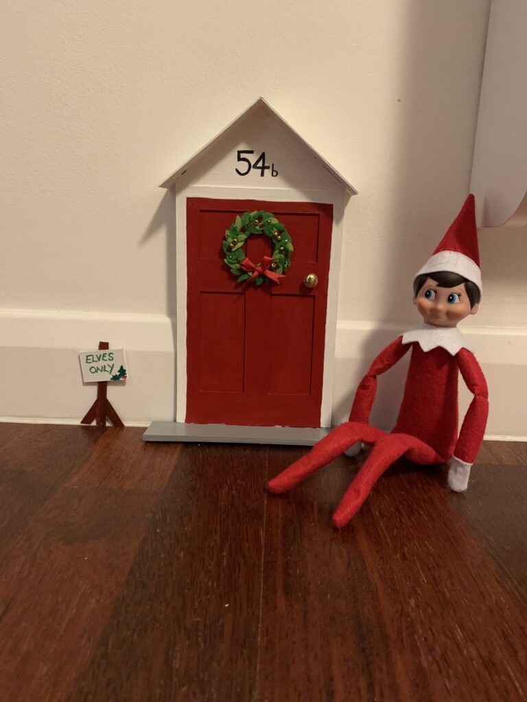 Elf on the shelf sat by his front door
