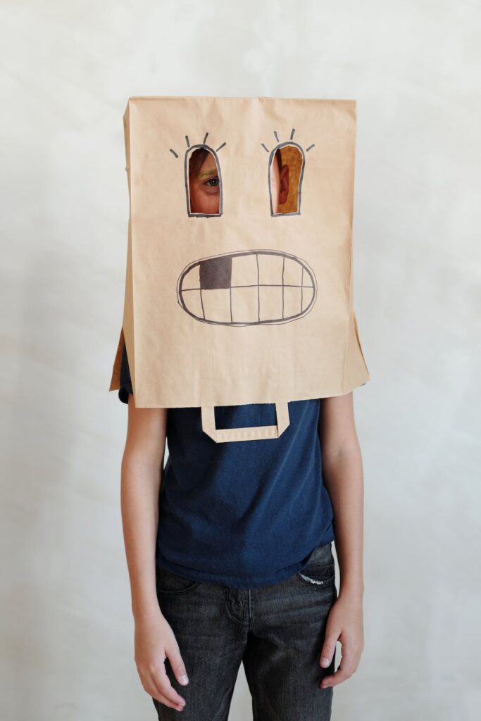 Child with a spooky paper bag on their head