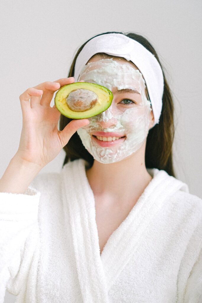 A girl with face mask and an avocado