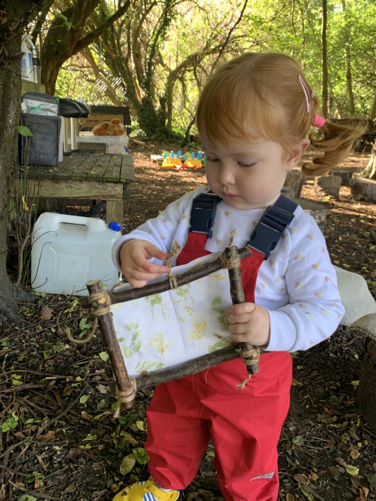 Lily holding her leaf printing