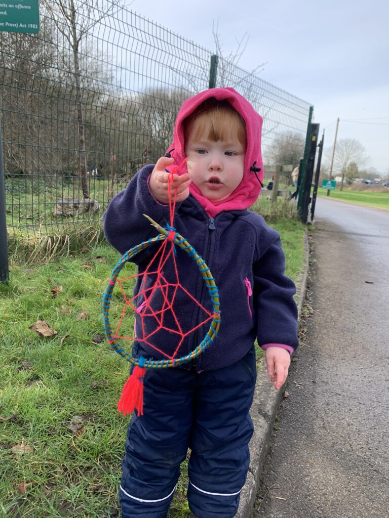 Lily holding her craft activity