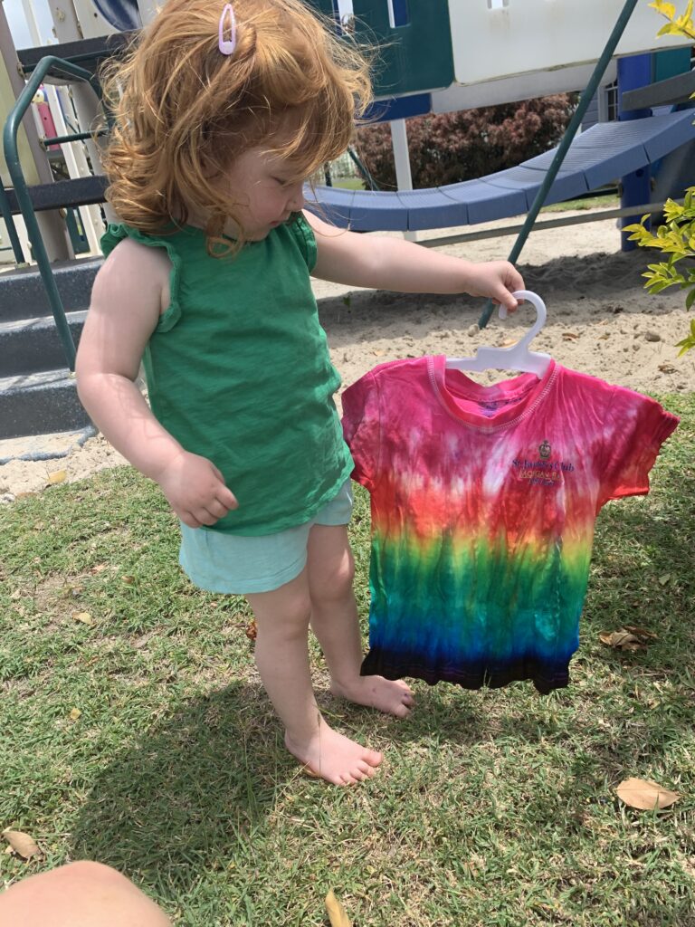 Lily holding her tie-dye t-shirt