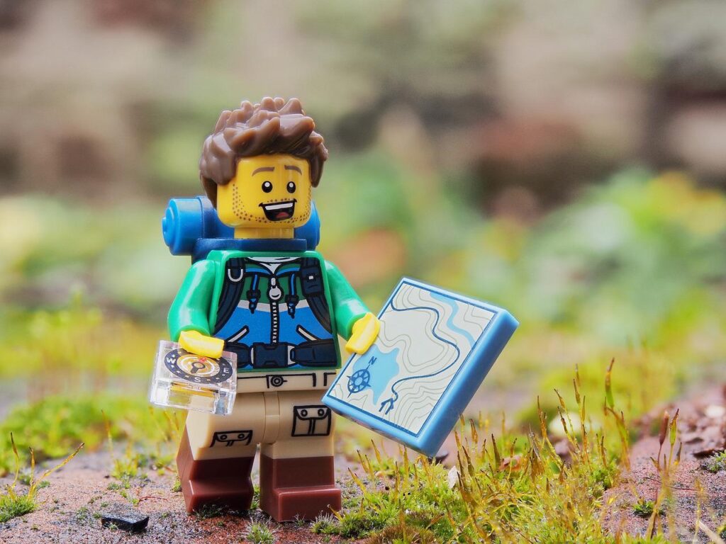 Lego man with back pack and map