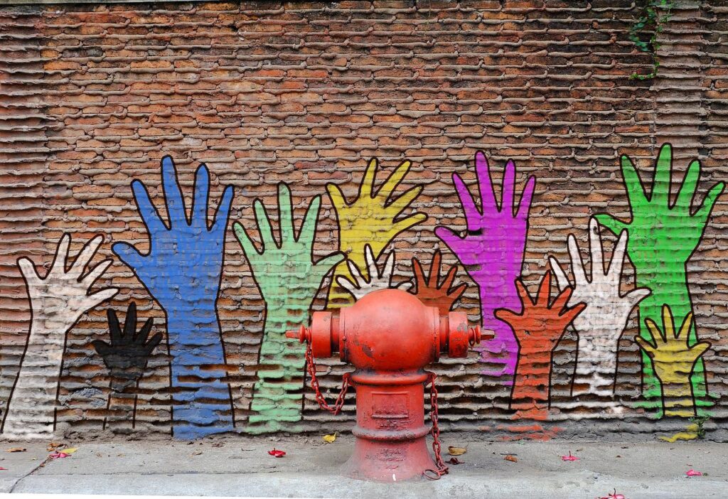 Raised hands painted on a wall