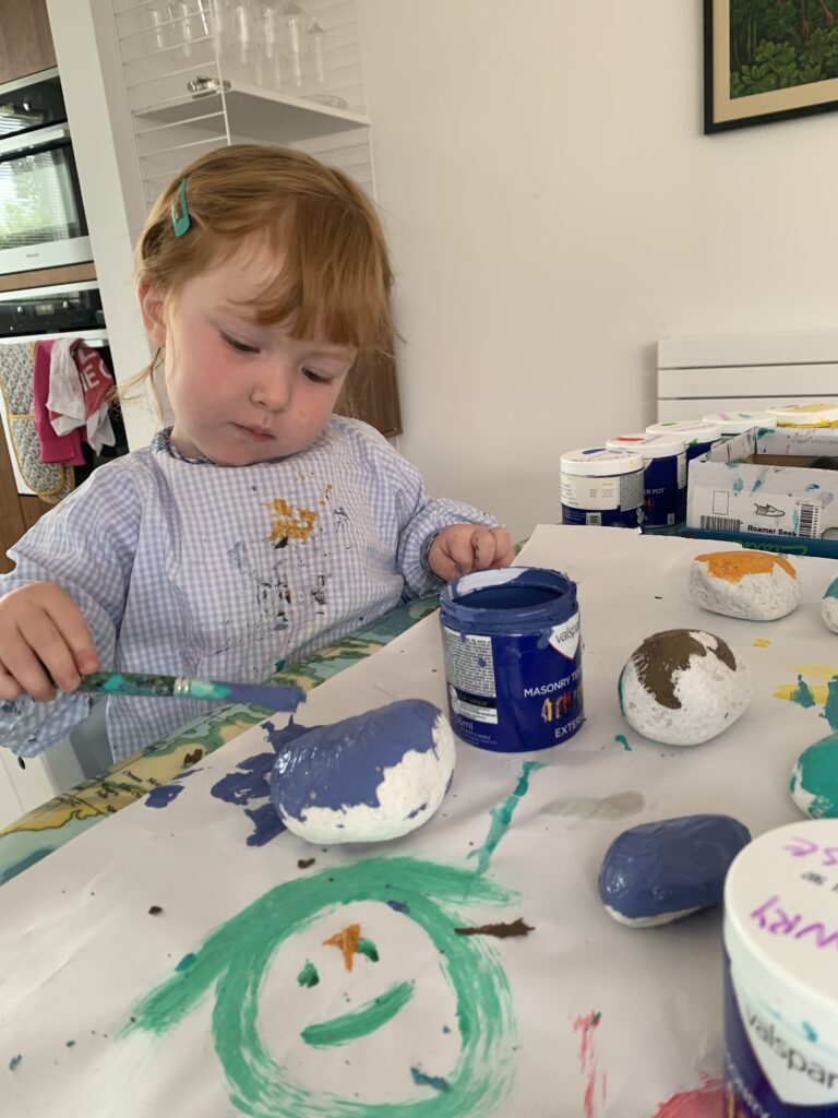 Lily painting rocks