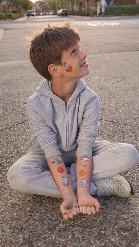 Boy with temporary tattoos on his arms