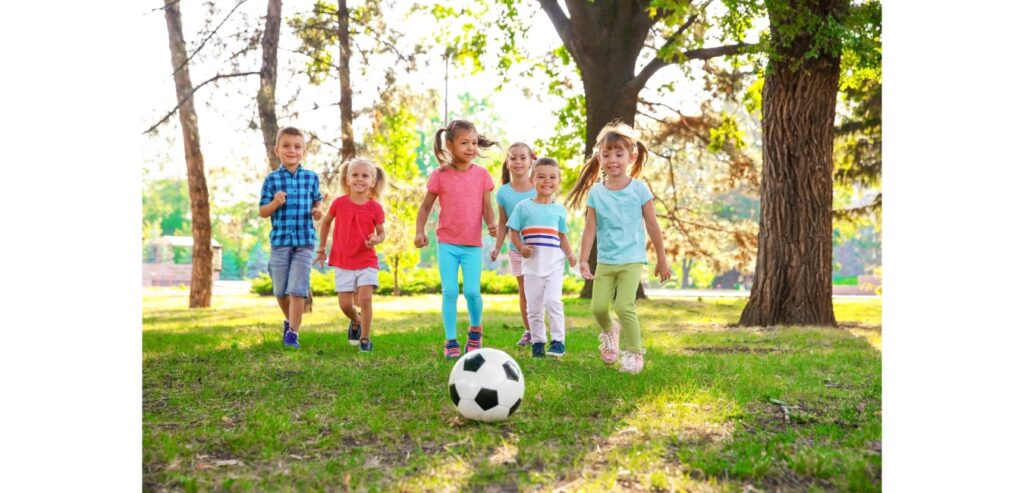 Group of children in the park with a football