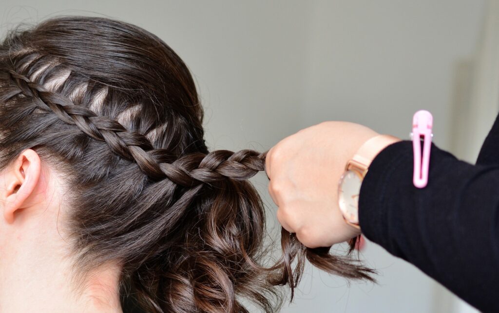 Someone braiding platting hair