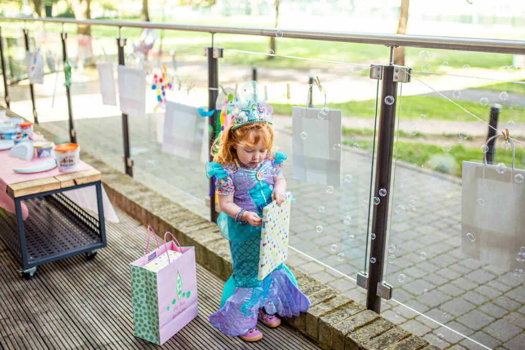 Lily with the washing line behind her to pin up the artwork