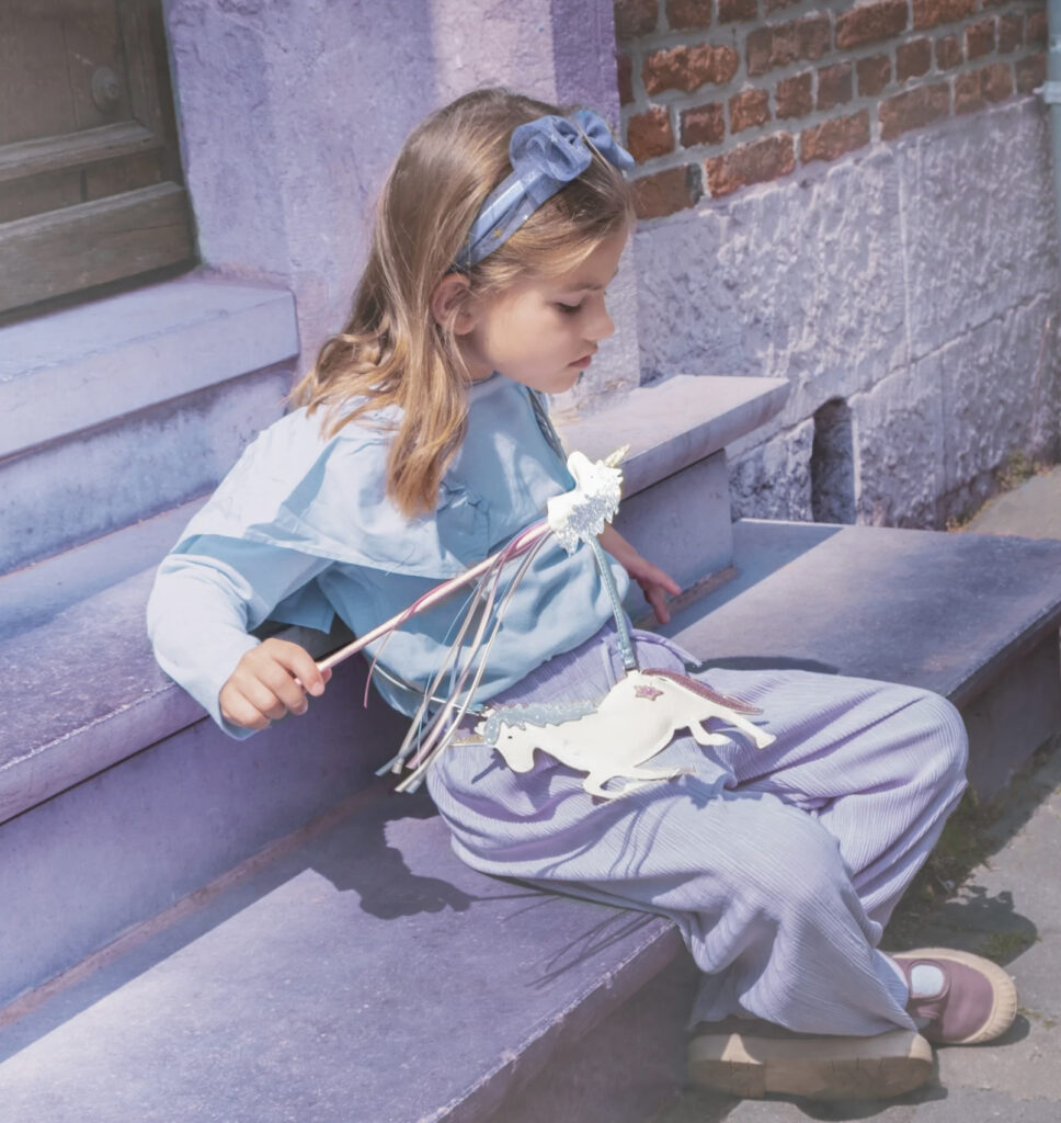 Girl with unicorn wand and bag