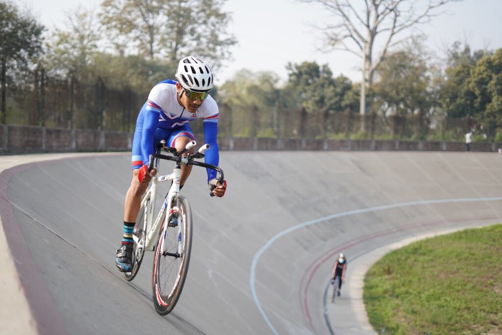 Cyclist on bike at velodrome