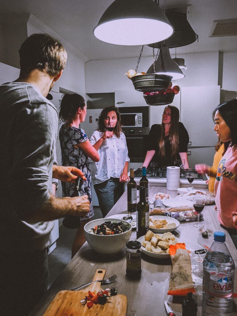 Group of people learning how to cook with a chef - Teenage birthday party ideas