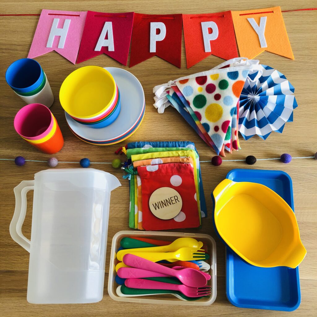 Piles of coloured plates and birthday bunting