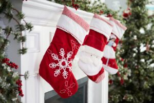 Line of red and white stockings hanging on fire mantle