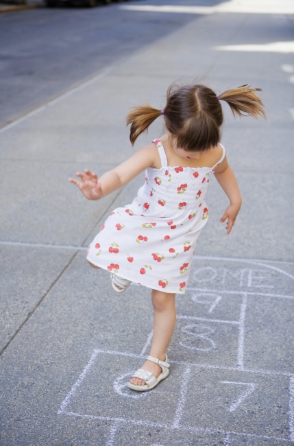Girl playing hopscotch