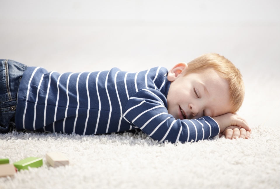 Little boy asleep on the floor