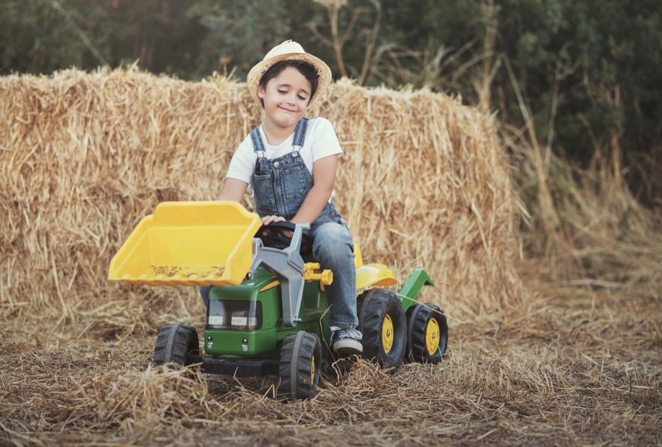 Little boy on a toy tractor