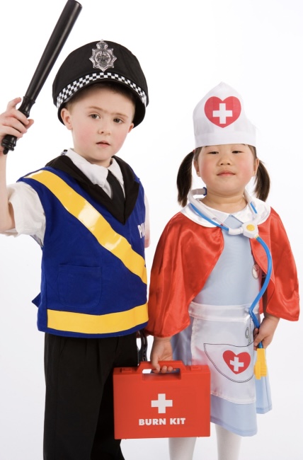 A little girl and boy dressed as a nurse and a policeman