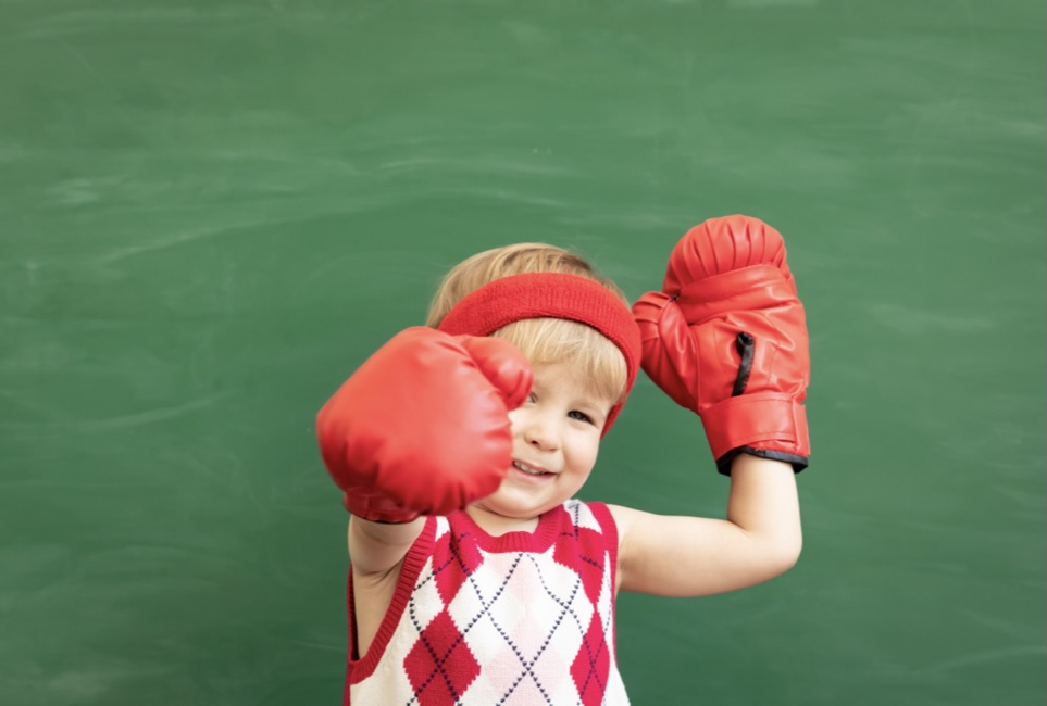 Boy with boxing gloves on