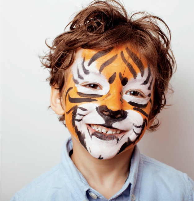 Boy with his face painted like a tiger