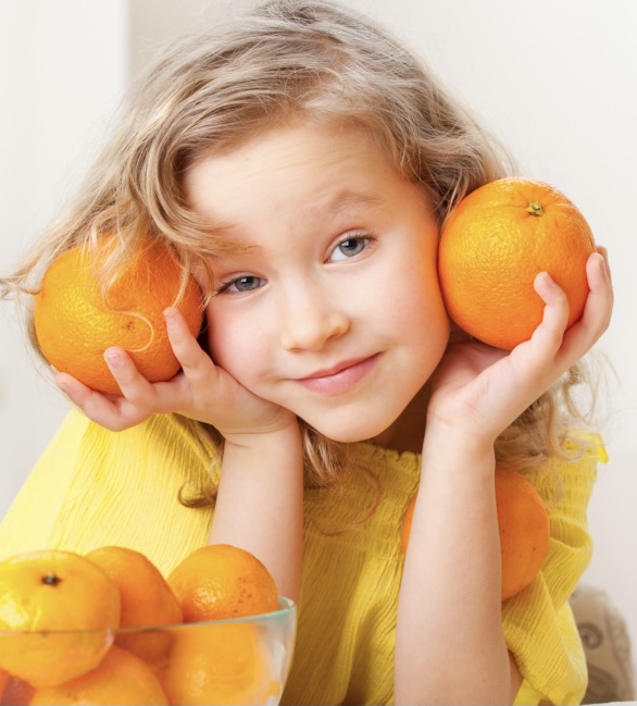 Girl holding two oranges