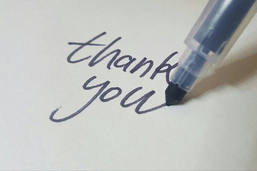 Someone writing thank you
