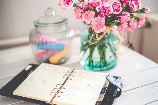 Diary and vase of flowers