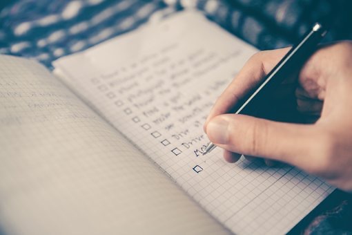 Someone writing a checklist