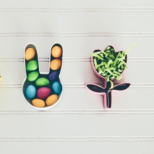 Two cookie cutters on a table filled with sweets