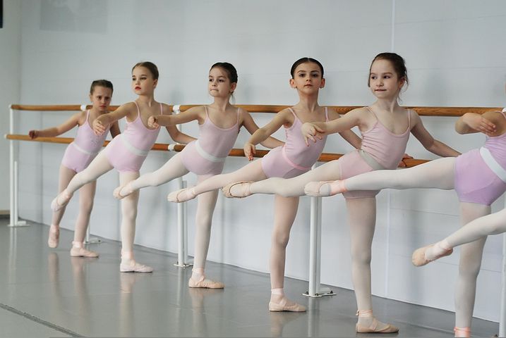 Line of girls doing ballet at the bar
