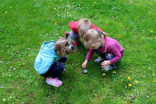 Children with a magnifying glass