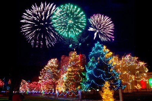 Christmas trees covered in lights and fireworks