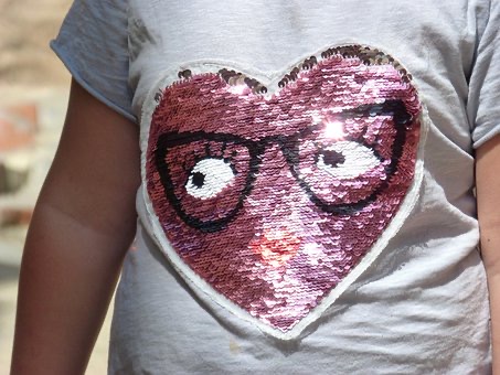 Girl with pink heart sequin on t shirt