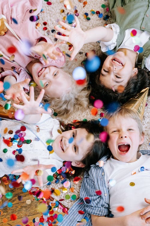 Children on the floor with confetti