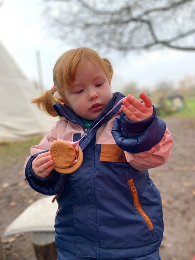 Lily eating s’mores - Forest school style parties