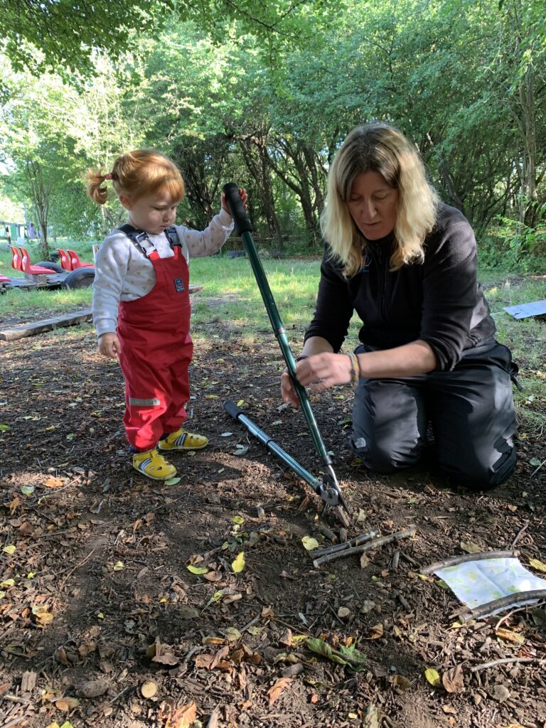Lily learning to use loppers - Forest school style parties