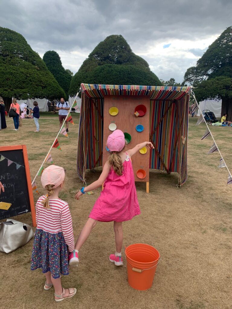 Girls playing bucket pong - Carnival style party games