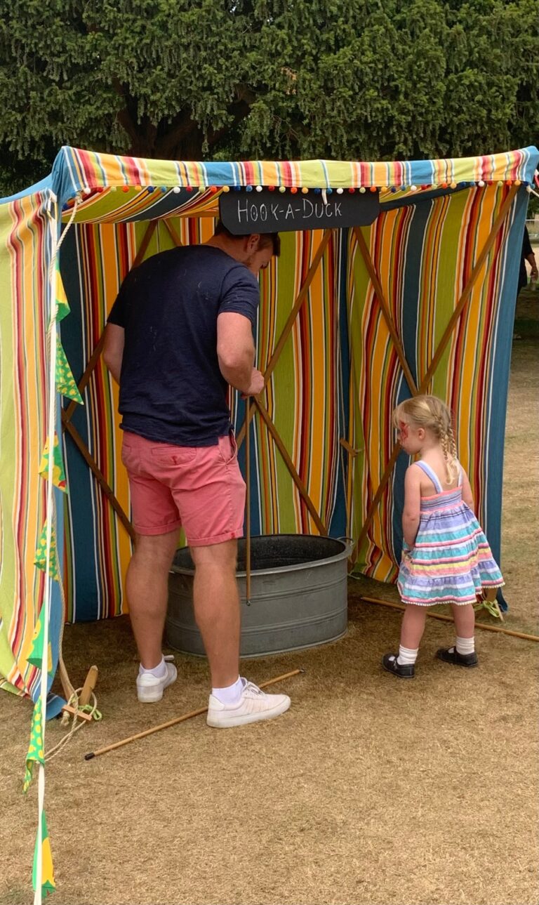 Girl playing hook a duck.- Carnival style party games