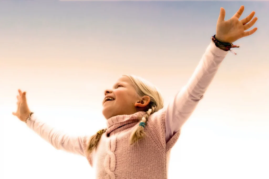 Happy girl with arms in the air